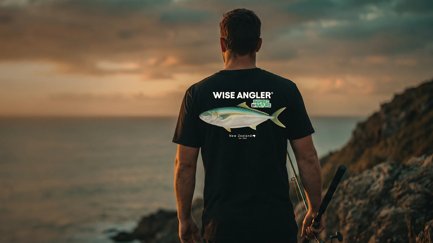 Angler at golden hour in the 30 lbs Club Kingies Edition tee, kingfish print on the back