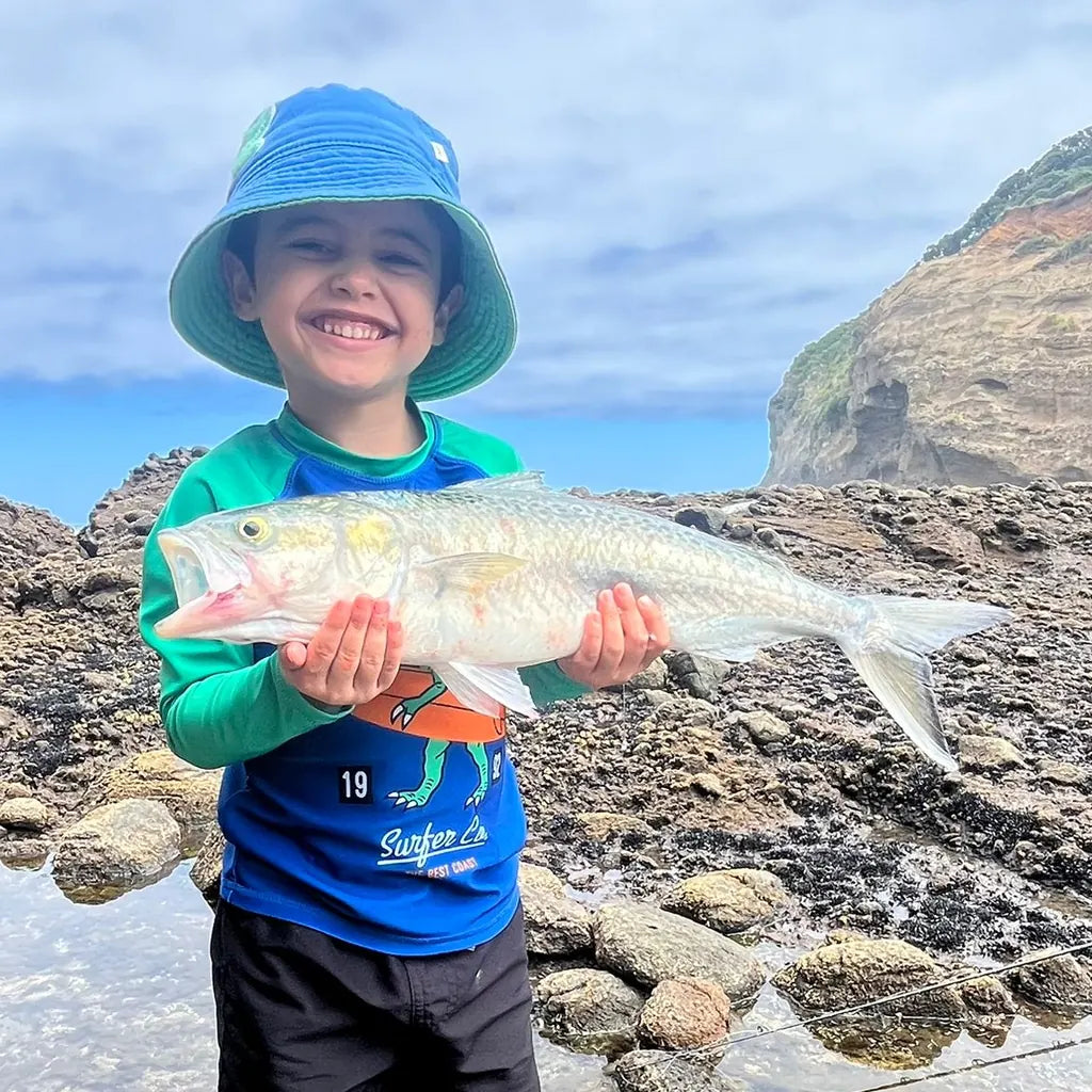 Young angler with a kahawai caught off the rocks
